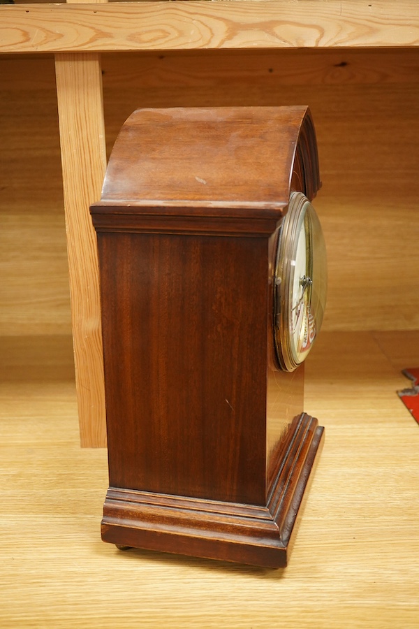 An Edwardian inlaid mahogany mantel clock striking on a coiled gong, 37cm. Condition - fair, untested